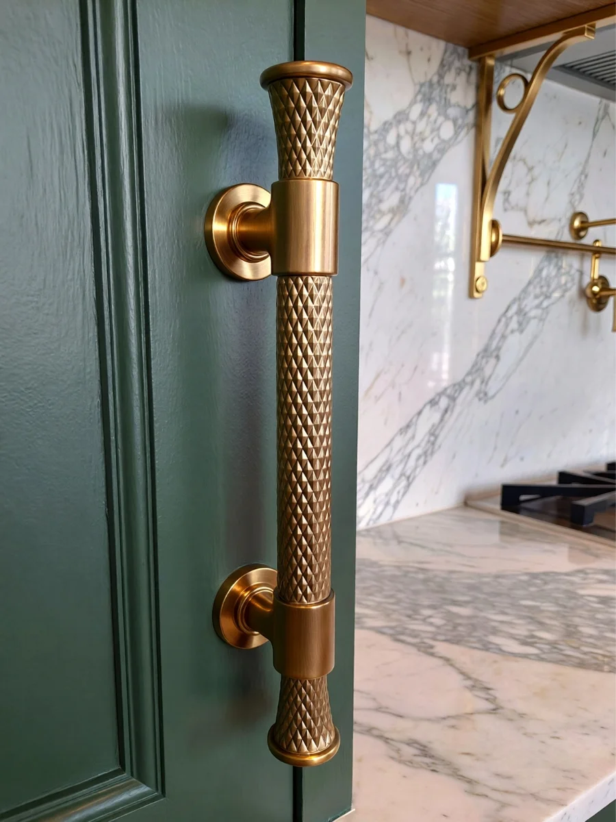 etail shot of solid brass knurled handles on sage green cabinetry showing affordable luxury interior design rules.