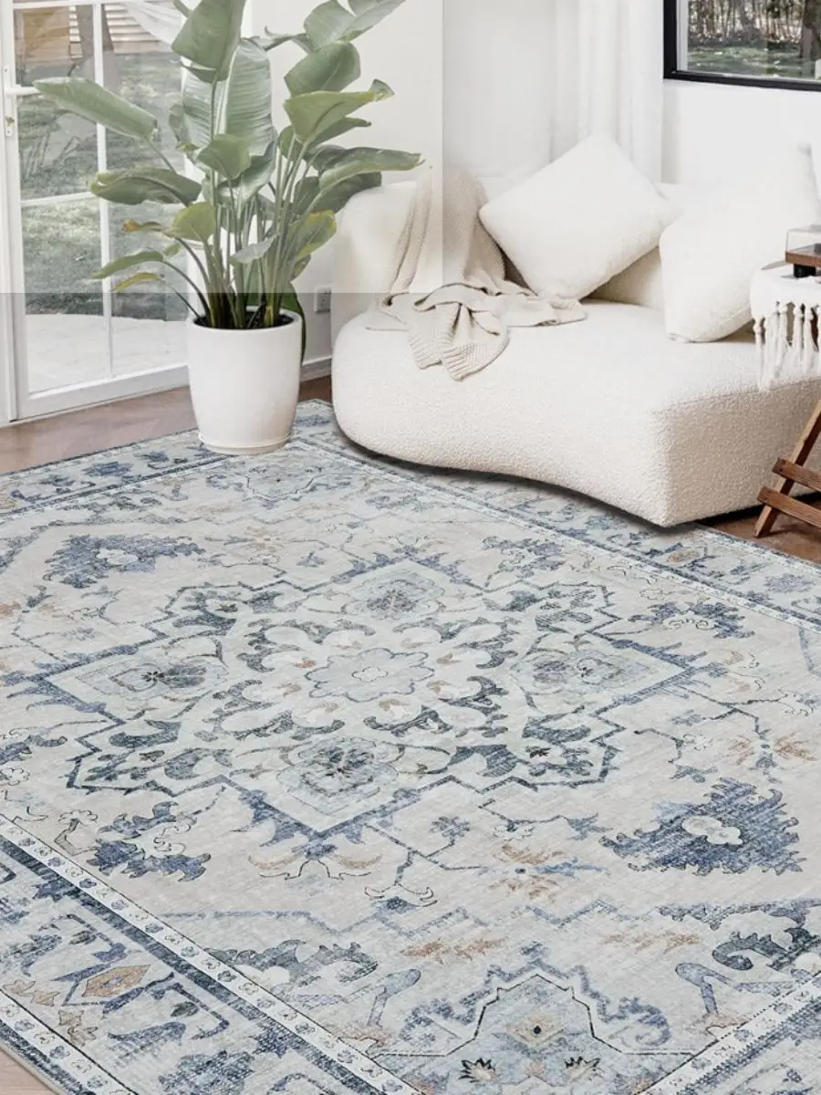 Joydeco 8x10 blue and grey vintage medallion area rug styled under a neutral sofa in a bright living room