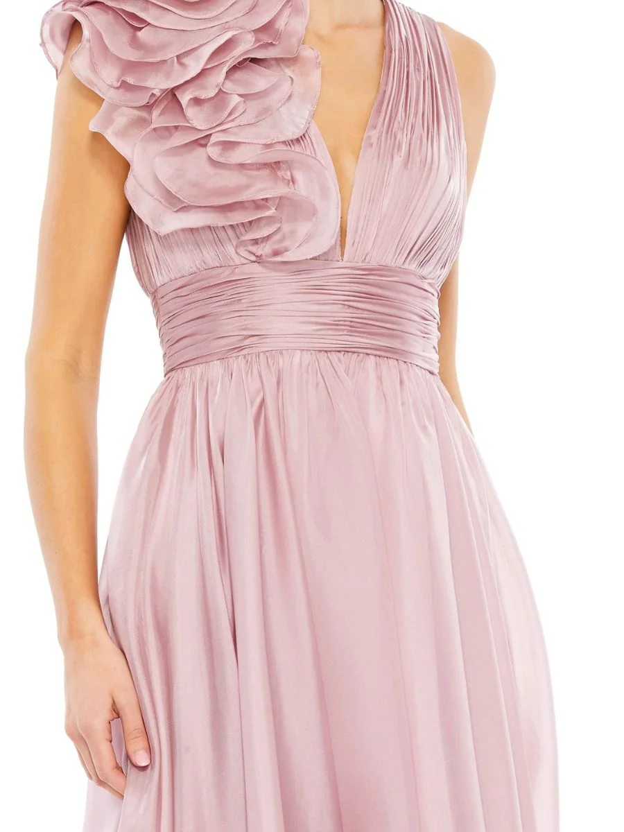 Macro view of a pleated mauve chiffon formal dress with a tiered ruffle shoulder design.