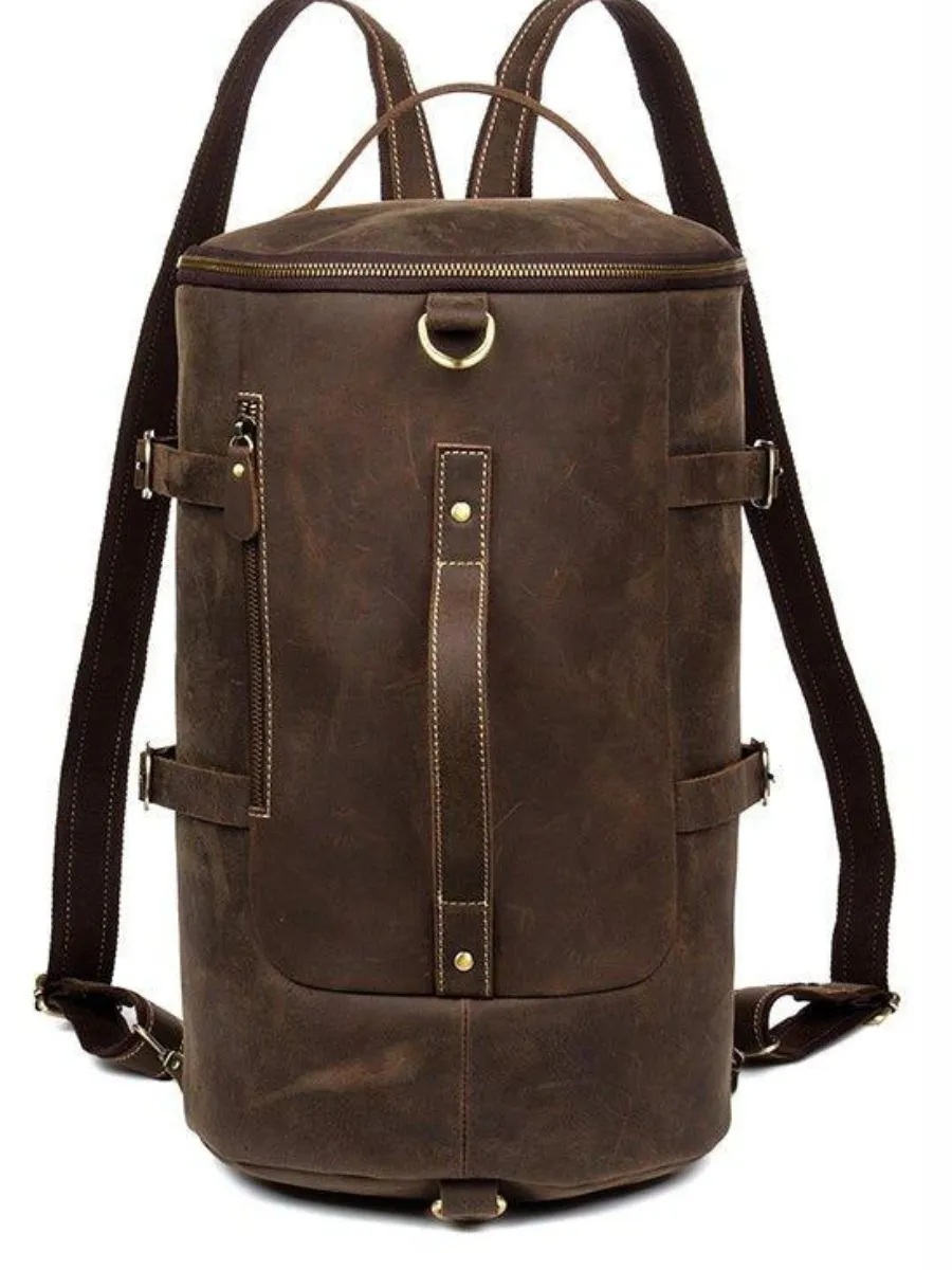A rugged large capacity vintage leather barrel backpack with heavy duty vertical stitching and robust shoulder straps.
