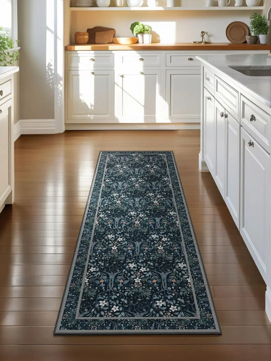 Joydeco floral washable runner rug in forest charcoal botanical pattern on hardwood flooring in a bright white kitchen.