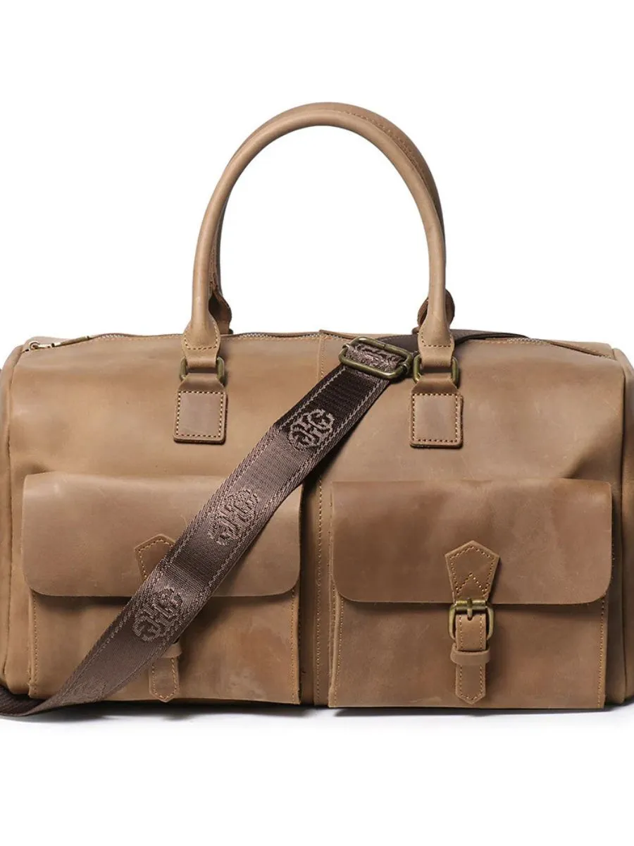 An elegant vintage leather weekender duffle bag featuring padded handles and an integrated laptop sleeve.