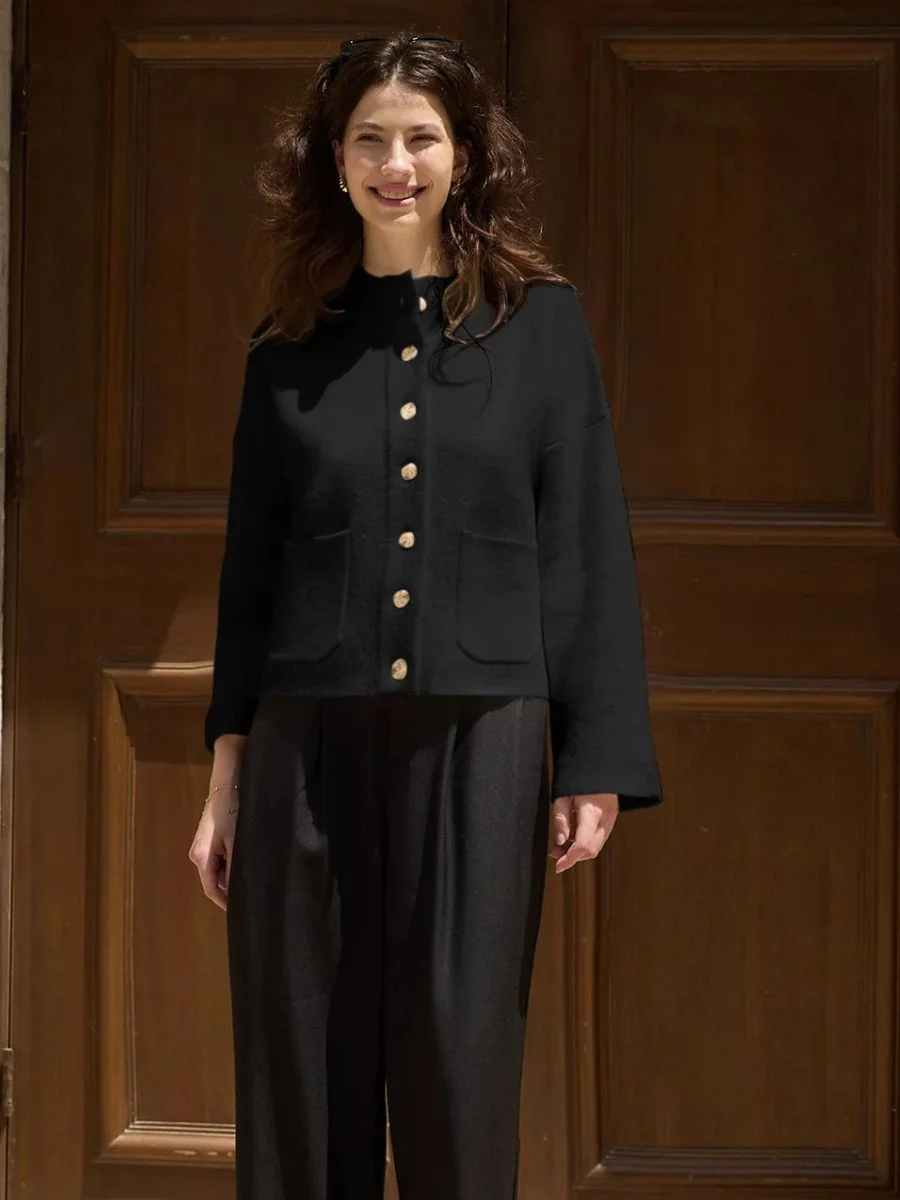 Cicy Bell black high waisted mock neck cropped sweater jacket with buttons on a model.