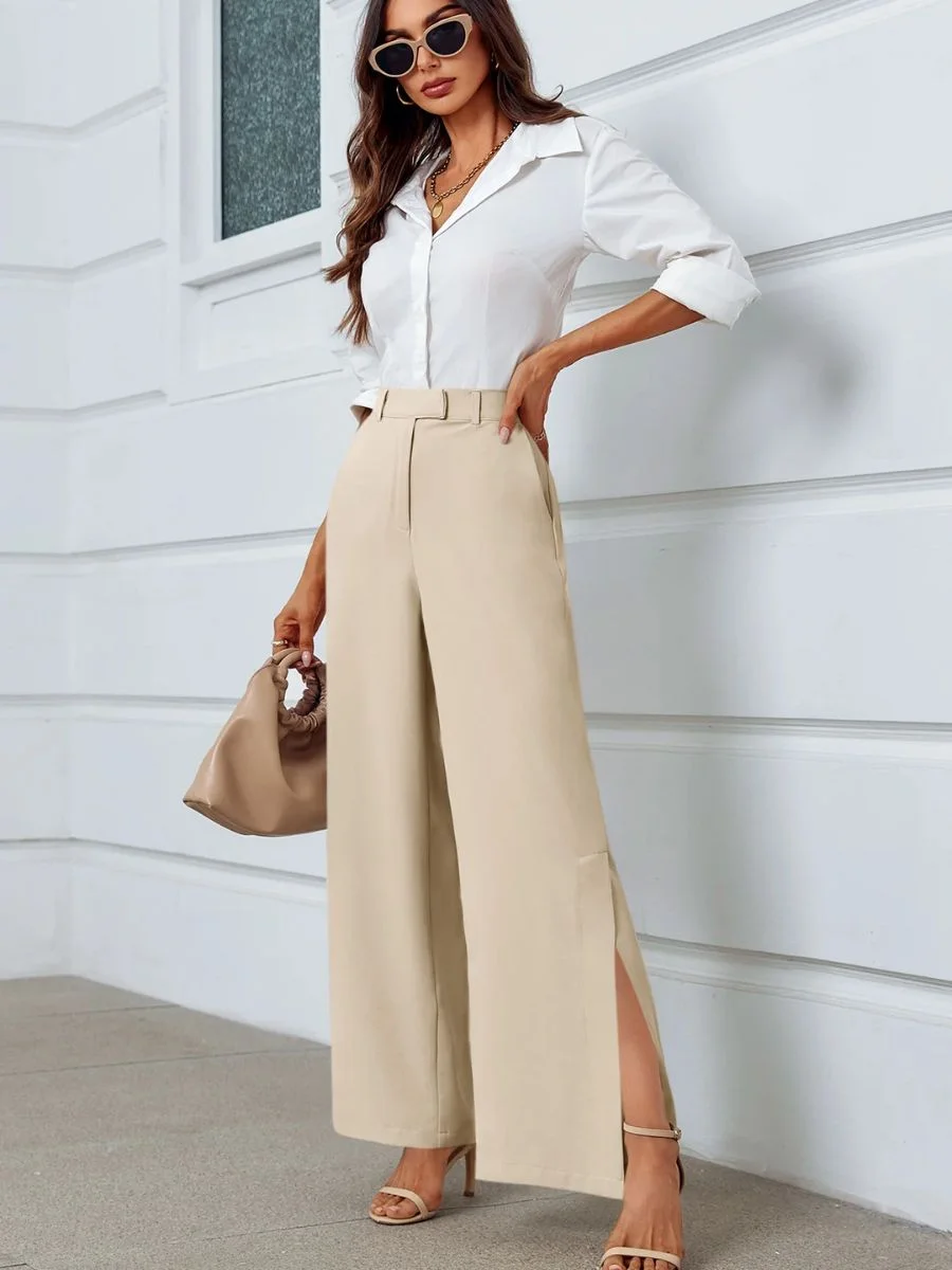 Cicy Bell light khaki high waisted wide leg dress pants with side split hem on a model.