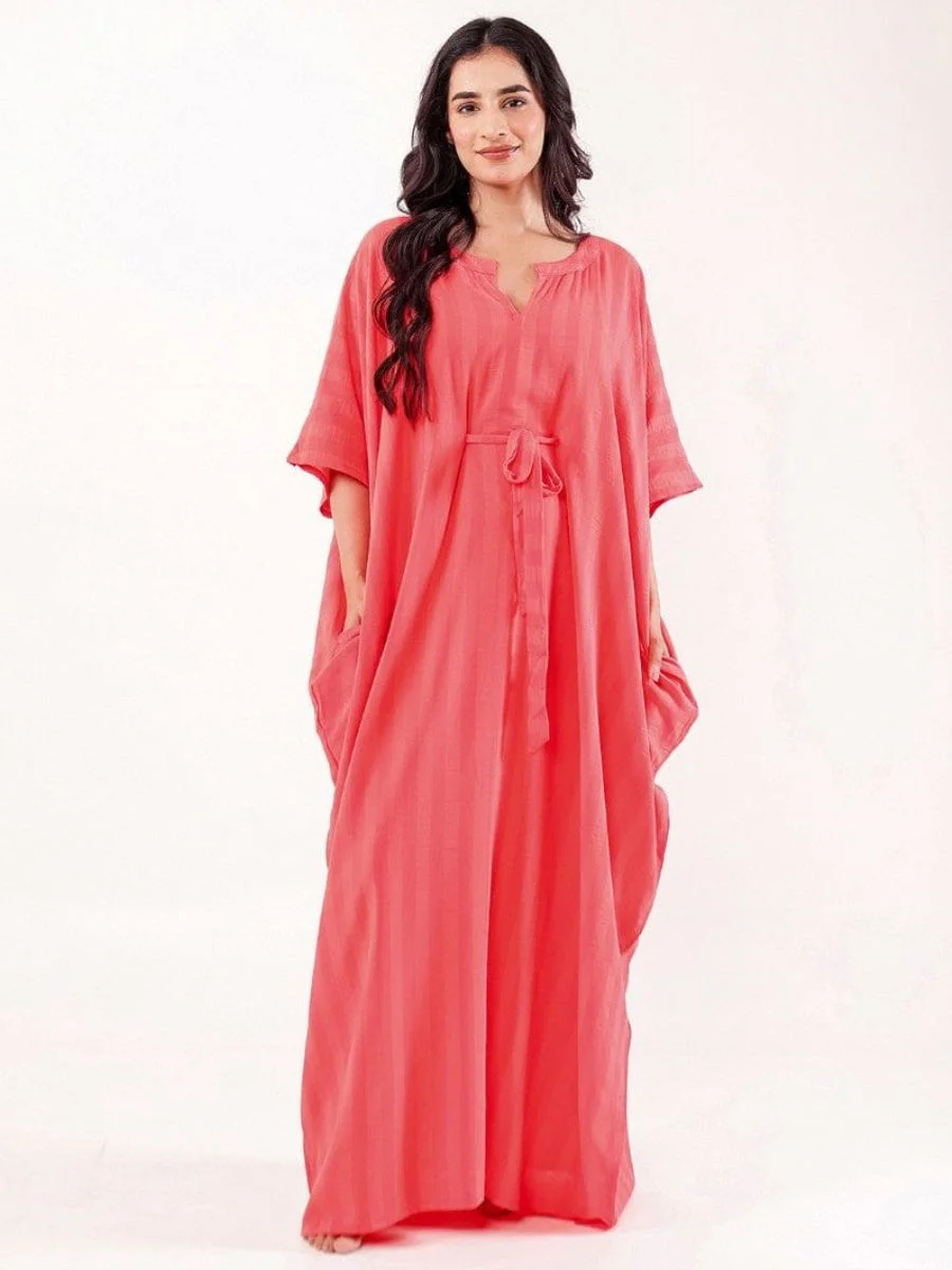 A vibrant coral solid modal freesize kaftan featuring an adjustable waist belt and wide flowing sleeves.