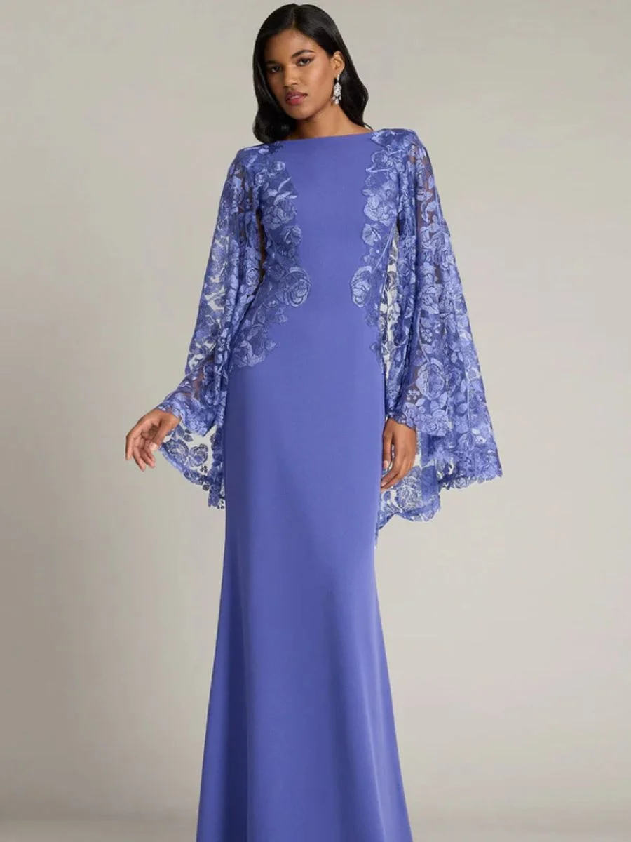 10 Stunning Long Purple Column Gowns for Your Next Black-Tie Event Model wearing a violet purple long sleeve column gown with sheer cape detailing and floral lace embroidery.