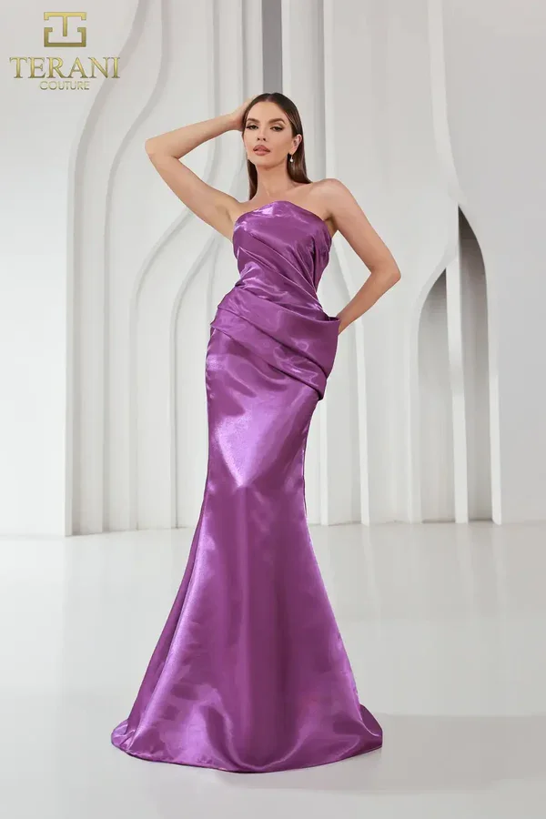 10 Stunning Long Purple Column Gowns for Your Next Black-Tie Event Model wearing a strapless purple column evening dress made of shimmering fabric that catches the light.