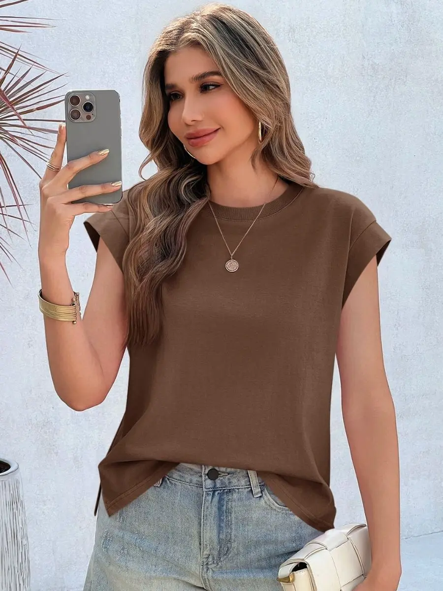 Front view of a woman wearing a coffee brown cap sleeve t-shirt with light wash denim shorts.