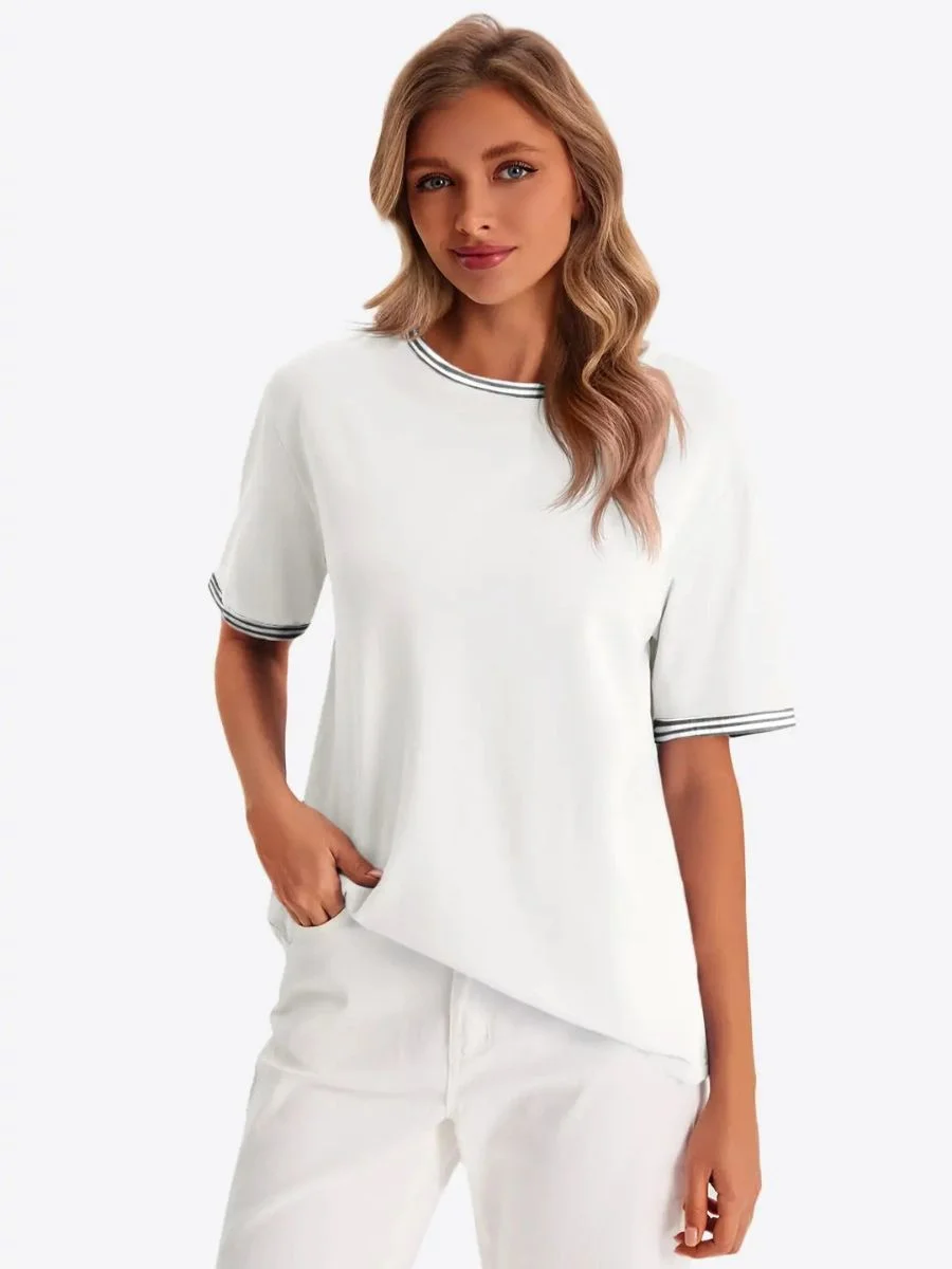 Womens White Summer Crew Neck T-Shirt with striped black trim tucked into high rise trousers.