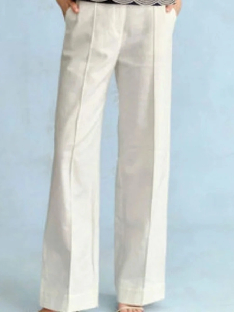 Soft white wide leg cotton pants styled for an all white outfit to demonstrate polished resort trouser tailoring.