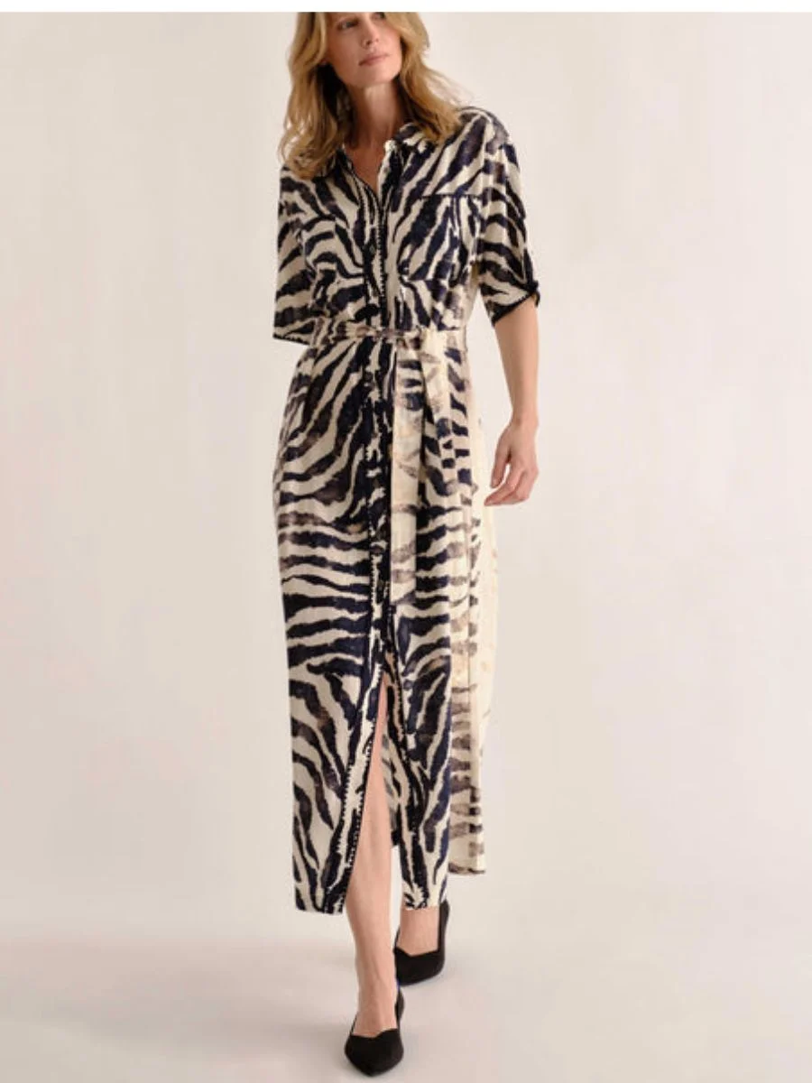 A striking black and white column silhouette, demonstrating how chic pre-fall transitional midi dresses adopt wild prints as alternative neutrals.