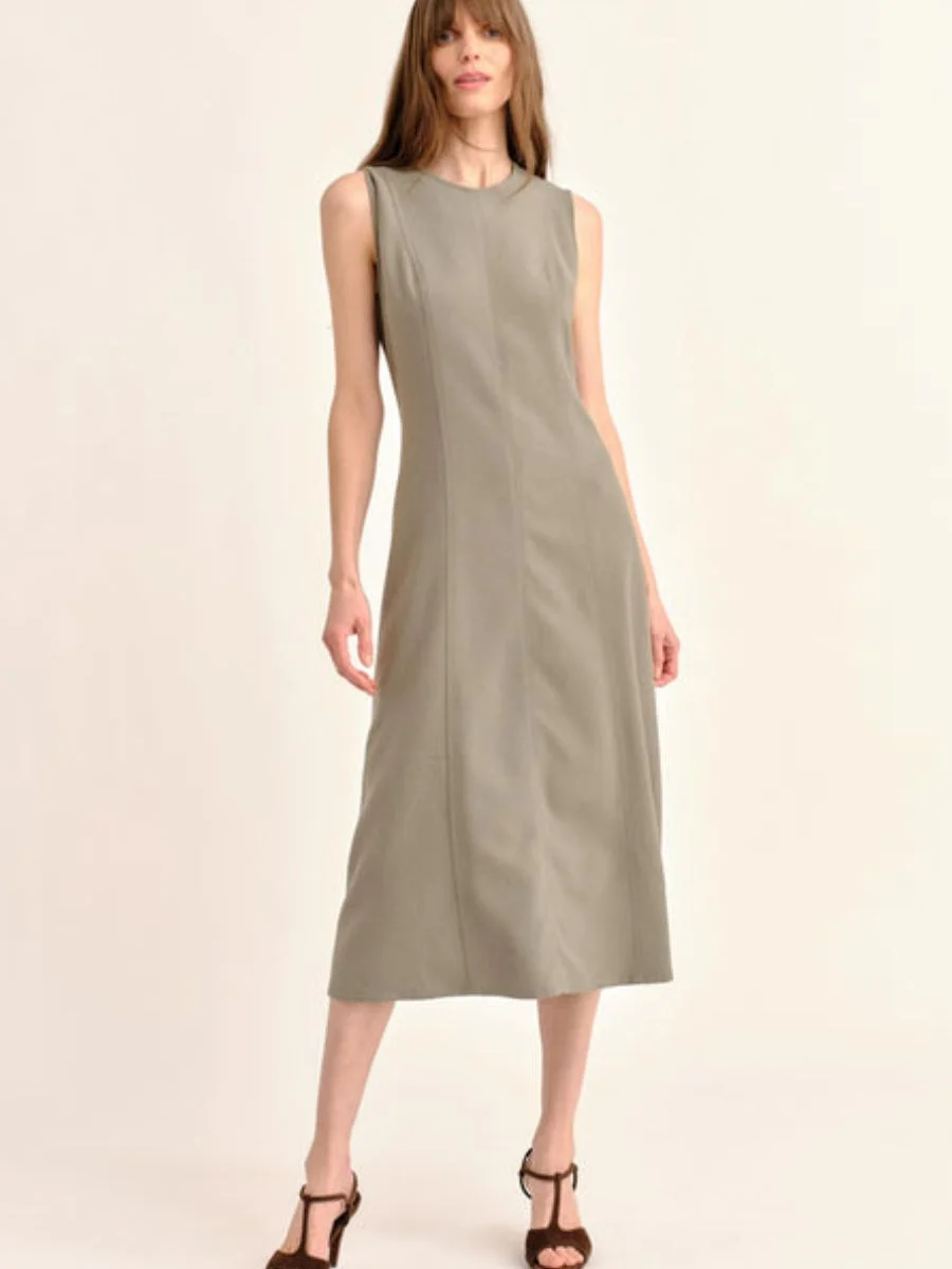  An elegant woman wearing the Cartolina Rain moss green crepe dress, a perfect example of chic pre-fall transitional midi dresses with a high neckline.