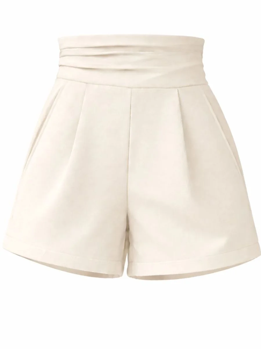Flat lay studio photograph of premium tailored cream high rise summer shorts from LuxeFashion showcasing front pocket alignments and crisp vertical trouser creases.