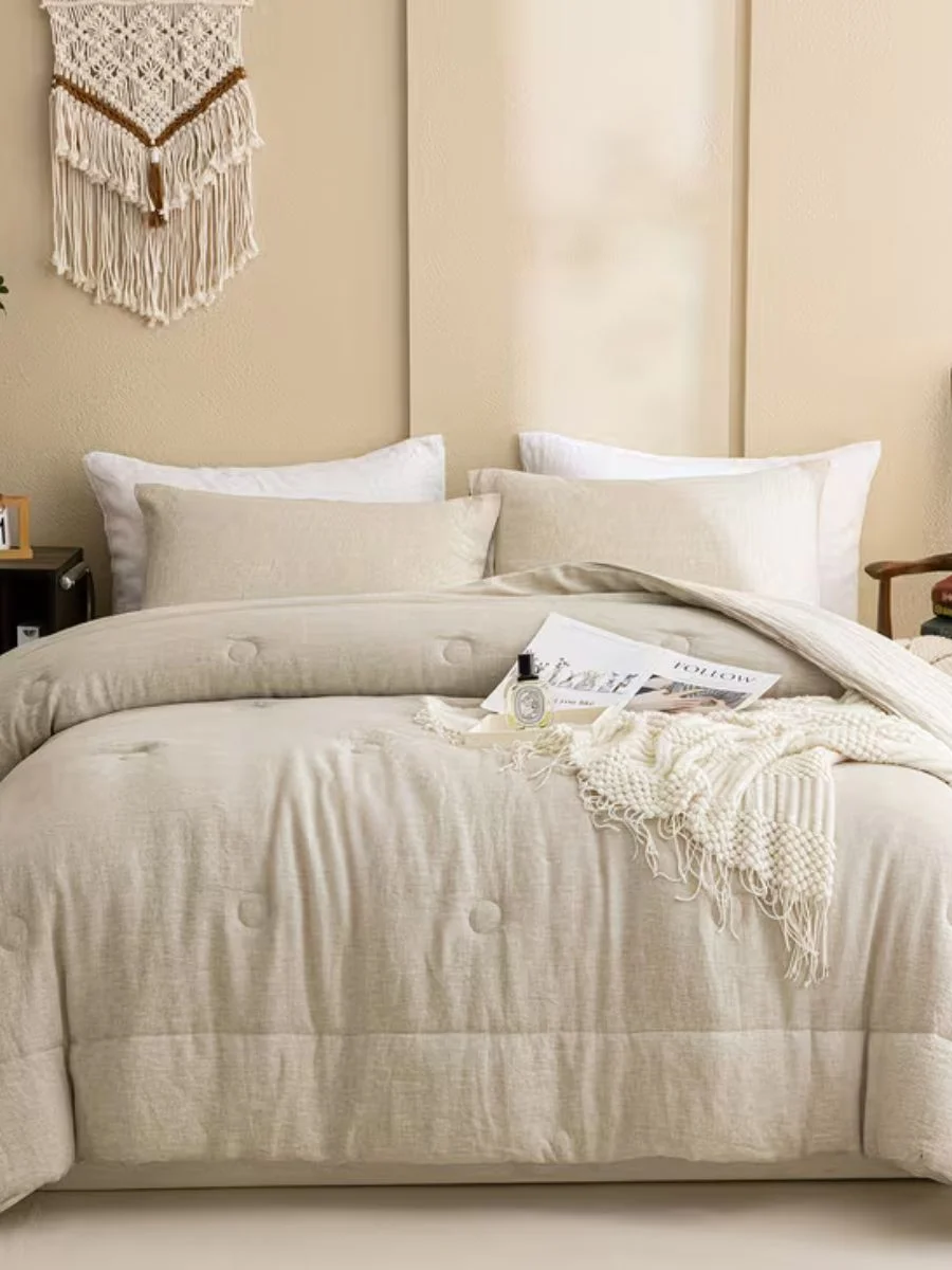 A cozy bedroom styled with a natural beige 100% French flax linen comforter set featuring tufted button details and matching pillows.