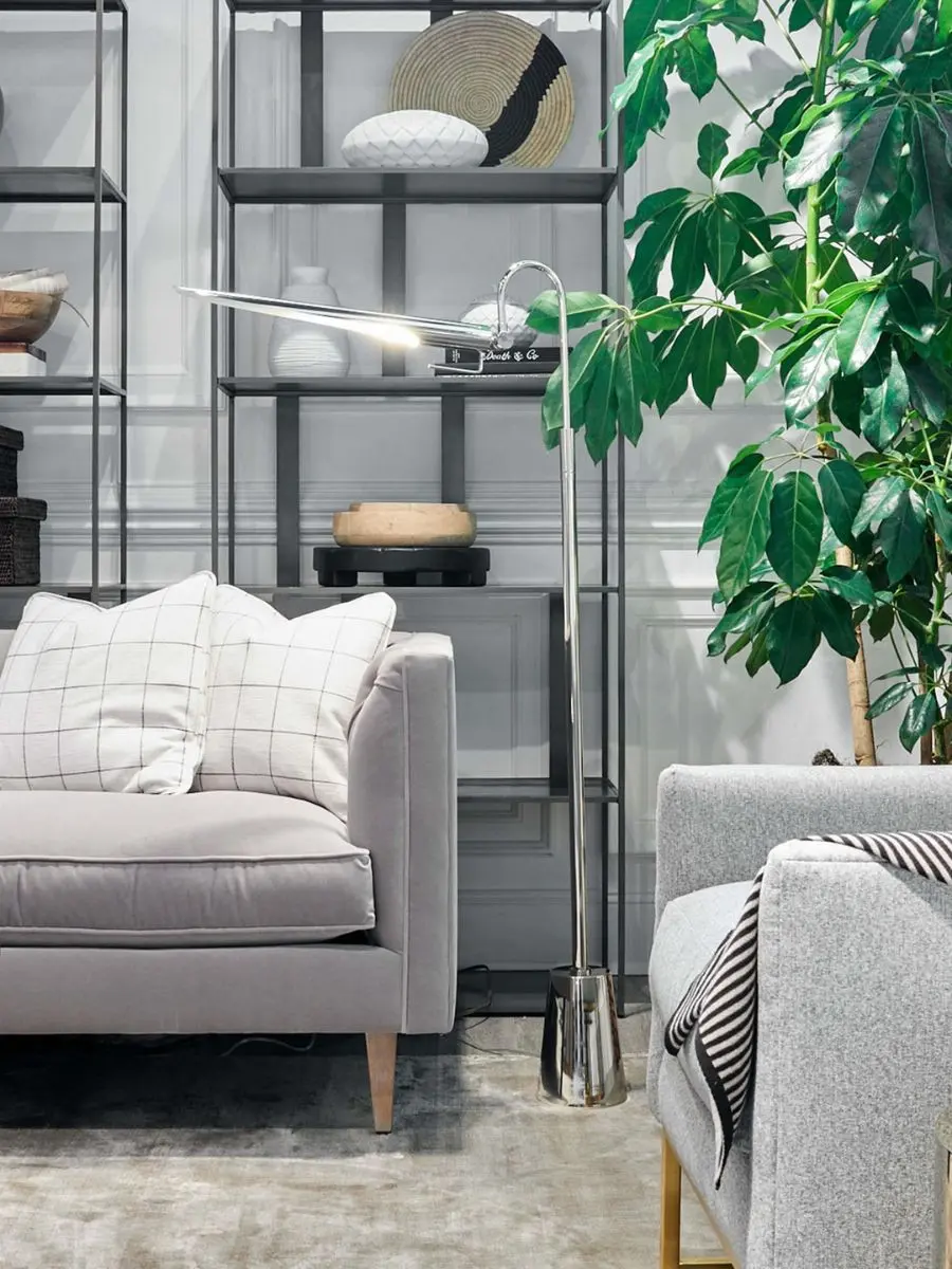 7 Layered Lighting Looks: How to Style Elegant Wall Sconces and Lamps Regina Andrew Raven Floor Lamp in polished nickel casting light next to a grey sofa in a modern living room.