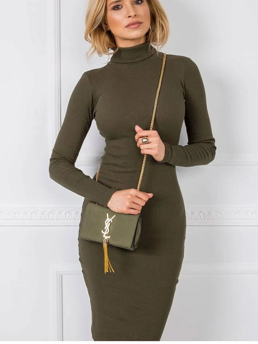 A woman modeling a long-sleeve olive green turtleneck style, showcasing how chic pre-fall transitional midi dresses hug the silhouette.