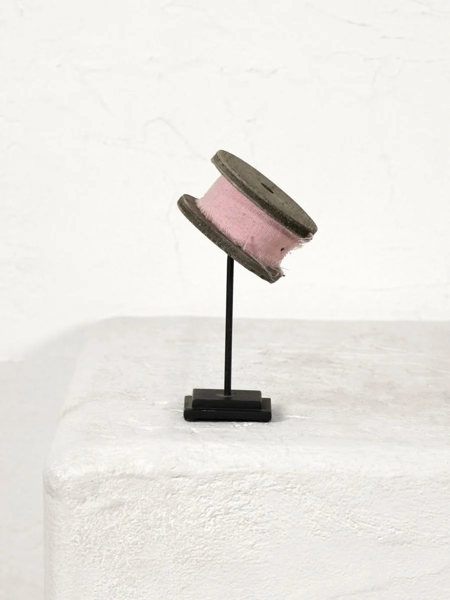 Old Money Home Decor: Easy Styling Steps to Make an Average Room Look High-End The one-of-a-kind Regina Andrew vintage wooden thread spool mounted on a black steel stand.