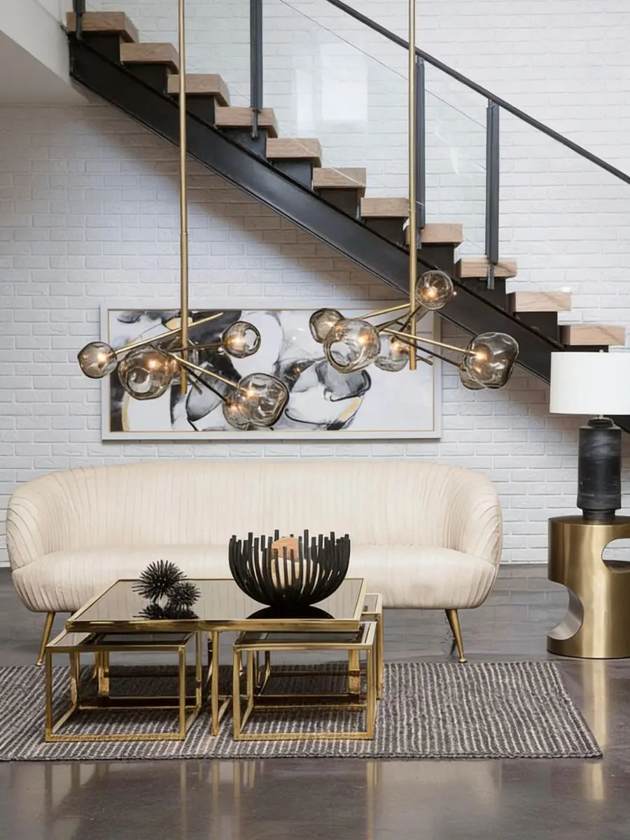 Old Money Home Decor: Easy Styling Steps to Make an Average Room Look High-End Sculpted blackened iron centerpiece bowl on a glass and gold nesting coffee table in front of a cream sofa. Modern transitional living room decor ideas.