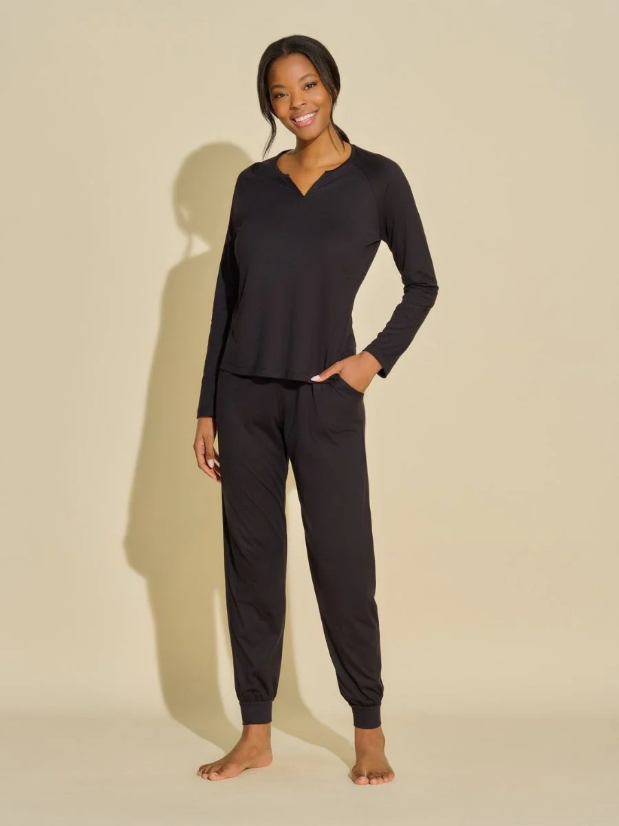 Model wearing the sleek jet black Cosabella long sleeve top and minimalist pima cotton modal jersey jogger lounge set.