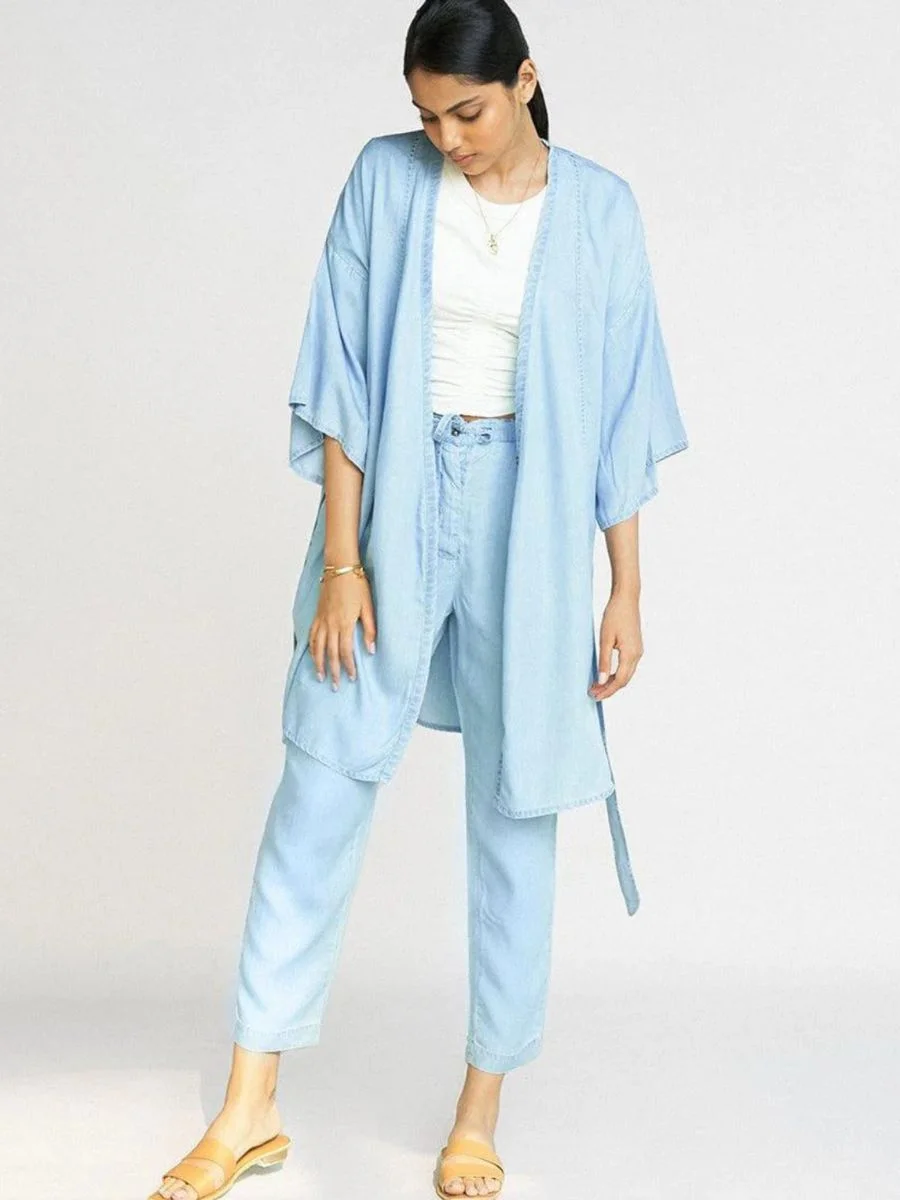 Model wearing the ocean blue Reistor eco-certified Tencel kimono jacket with loose matching lounge pants.