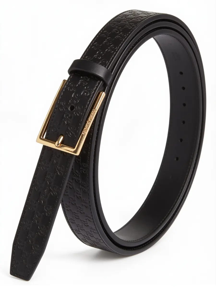 A black leather dress belt coiled in a loose loop, showcasing an embossed geometric monolink pattern along the strap and a square gold pin buckle.