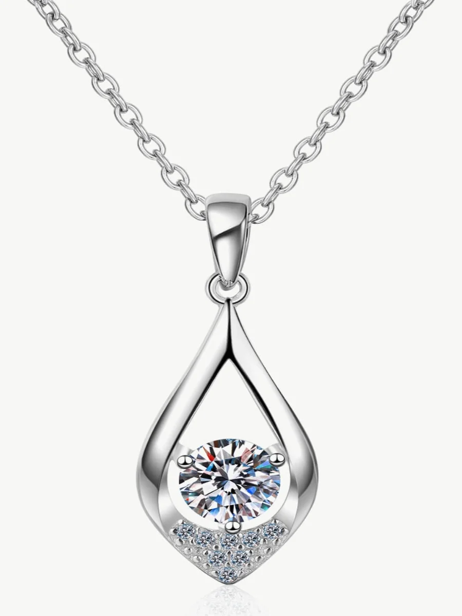 Silver teardrop pendant necklace holding a round cut white diamond stone with small pave accents at the base on a white background.