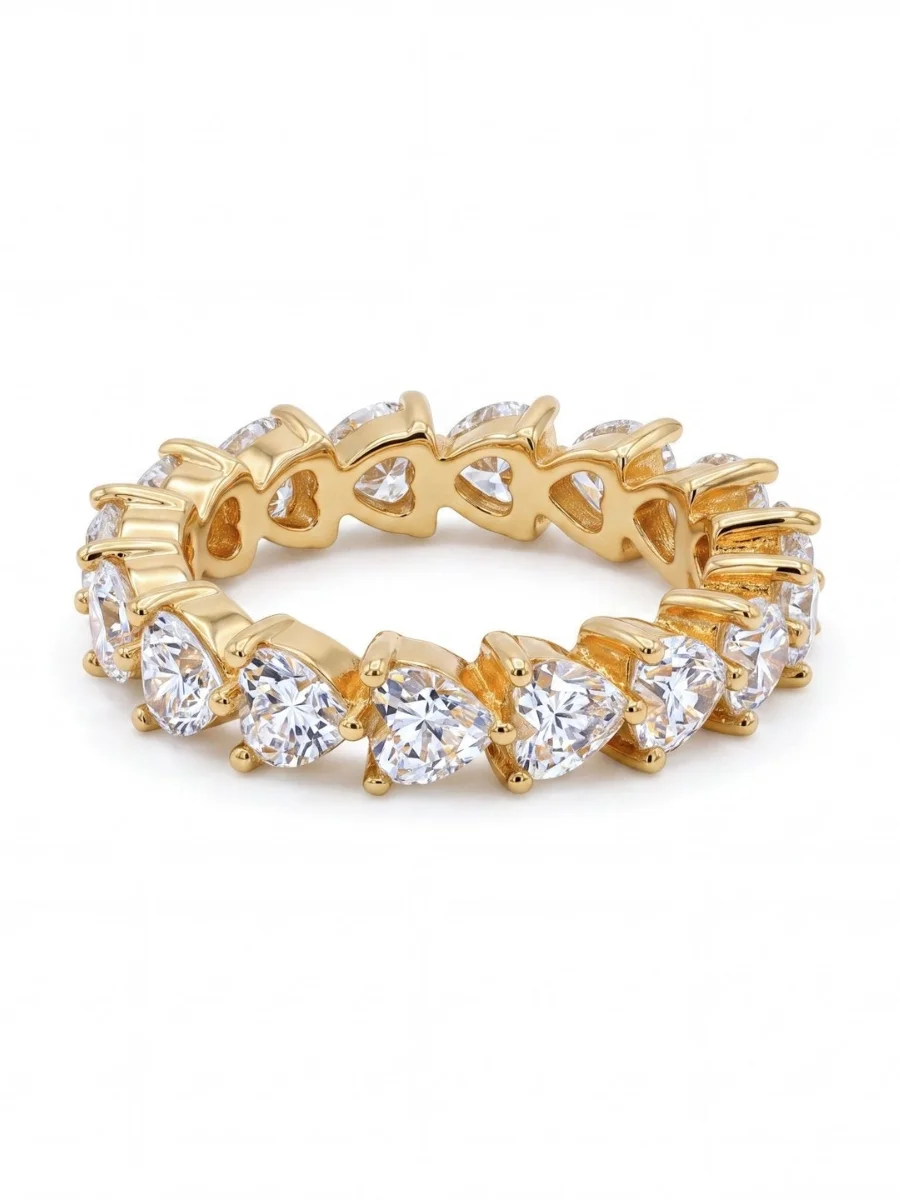 Gold plated silver eternity ring with a continuous band of heart shaped white zirconia stones on a white background.