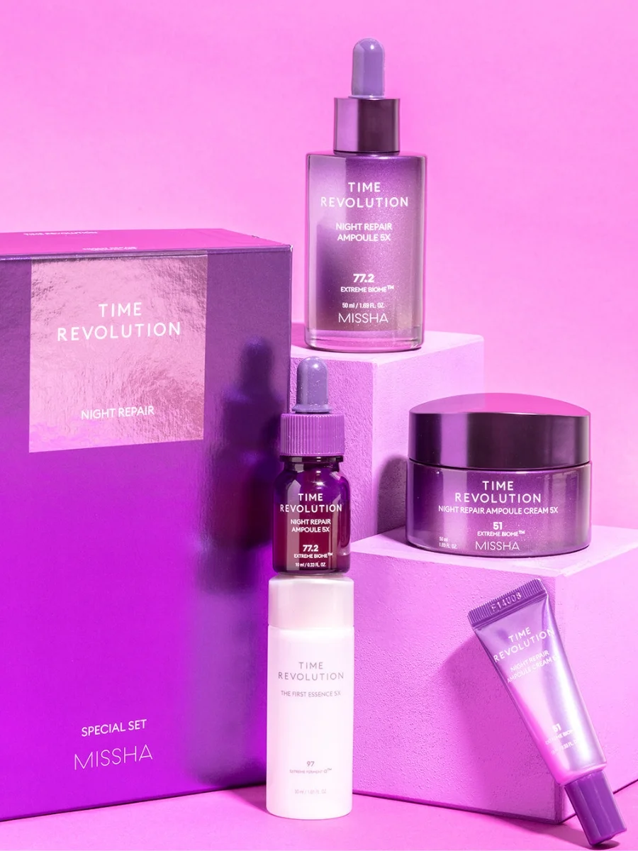 Missha Time Revolution Night Repair Special Set 5X including ampoule dropper bottles, essence cream jar, and skincare items against a purple background.