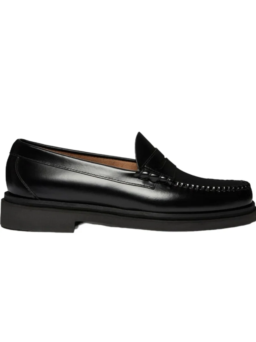 A side profile view of a classic black polished leather penny loafer from G.H. Bass featuring hand-stitched moccasin seams, a traditional cutout penny strap, and a chunky lightweight rubber sole against a plain white background.