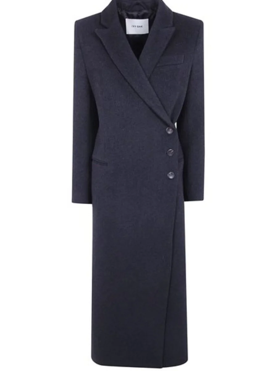 Ivy Oak Clio long wool coat in dark grey melange, featuring structured shoulders, classic notched lapels, and an asymmetrical side button closure.