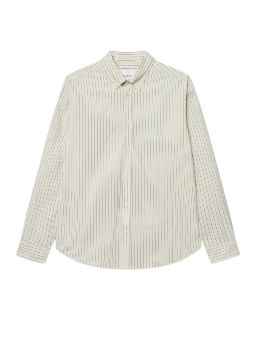 A flat lay view of the Kent striped poplin shirt from Les Deux featuring a light ivory base fabric with fine vertical dark pinstripes, long sleeves, buttoned cuffs, a classic pointed collar, a full button-up front placket, and a single chest pocket on a plain white background.