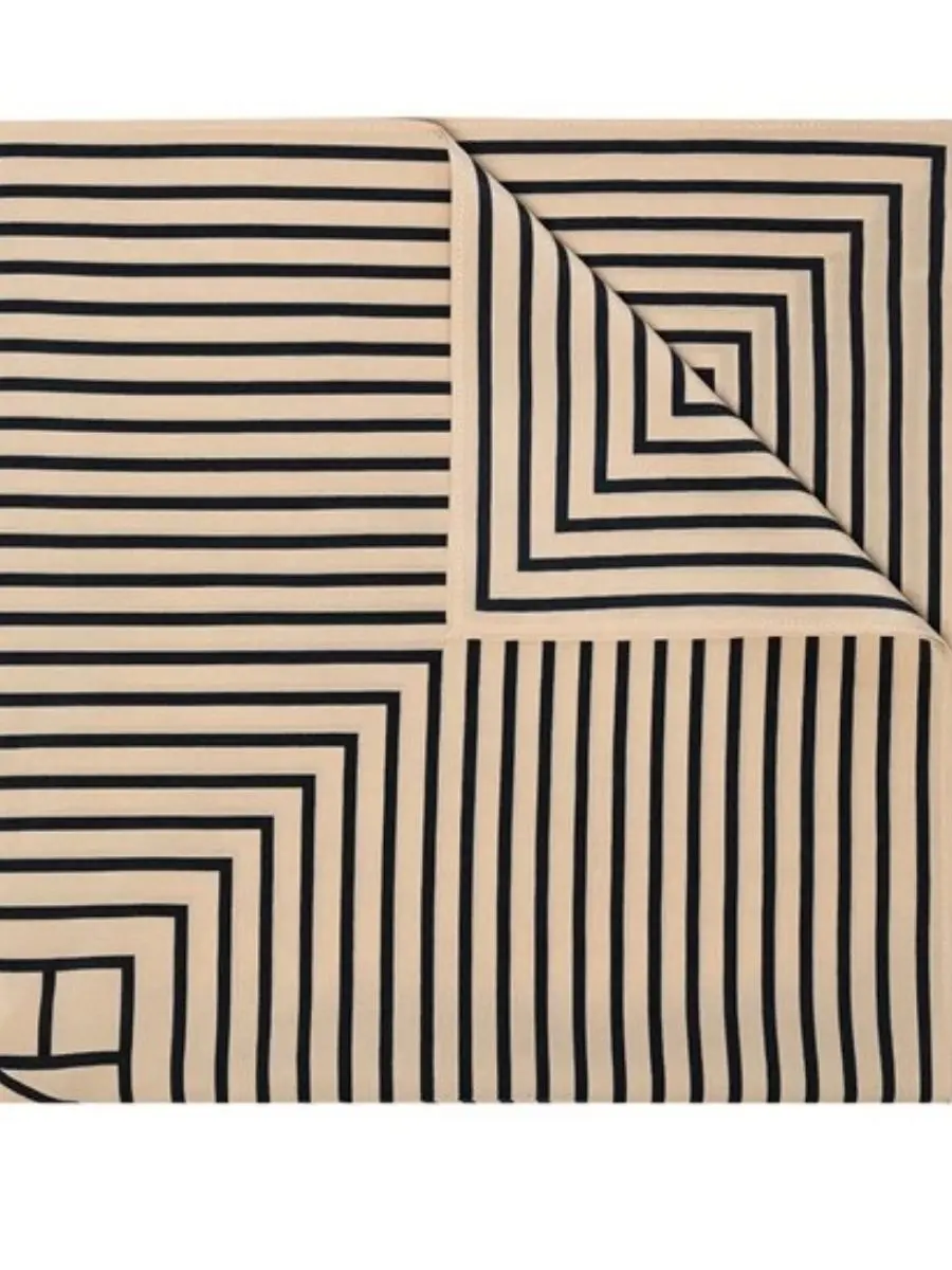 Toteme Signature silk scarf in a cream and dark neutral colorway, featuring a geometric monogram line pattern layout.