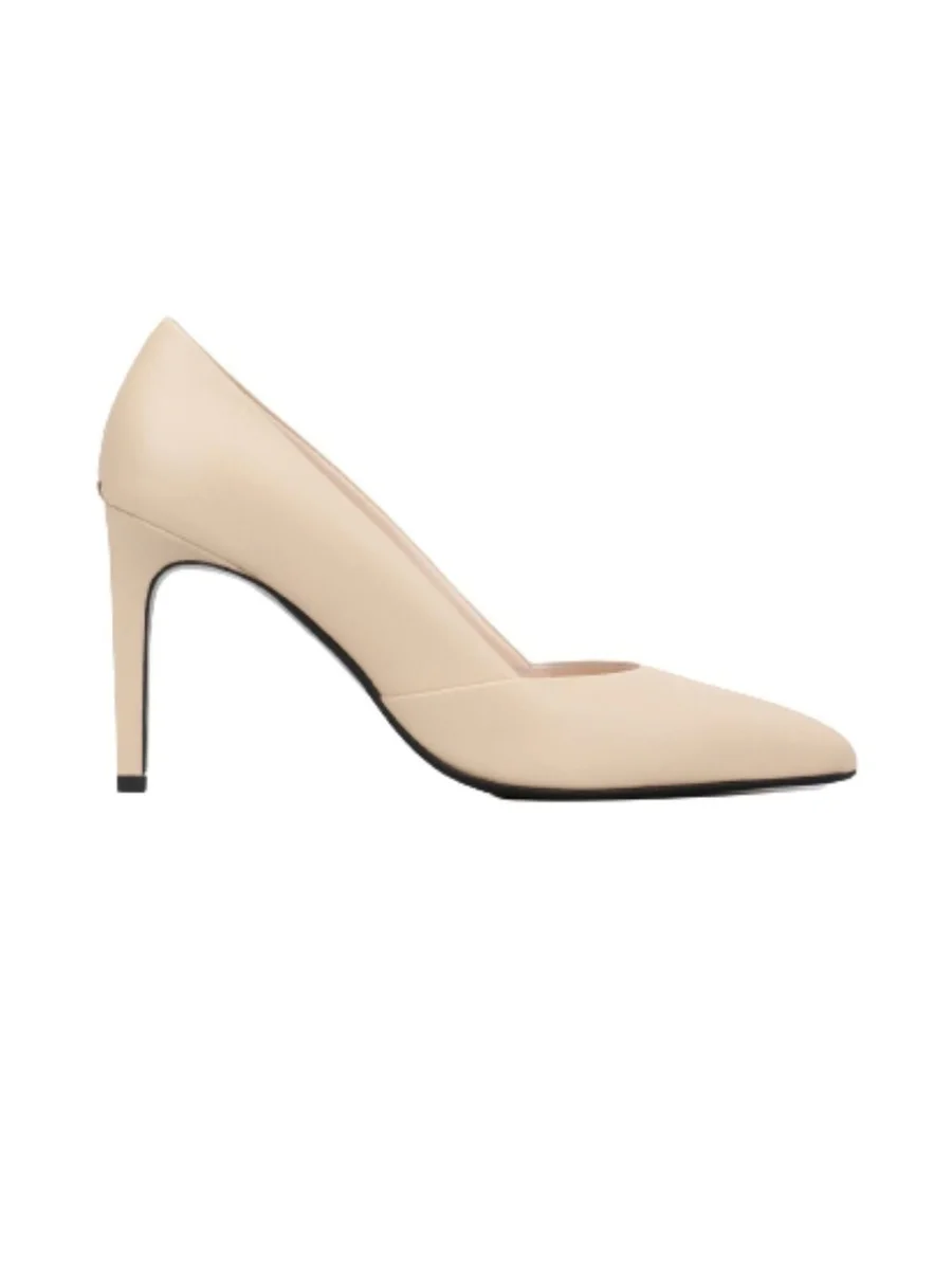 A side profile view of a beige leather stiletto pump from Calvin Klein featuring a pointed toe, a seamless upper, and a 90mm heel against a plain white background.