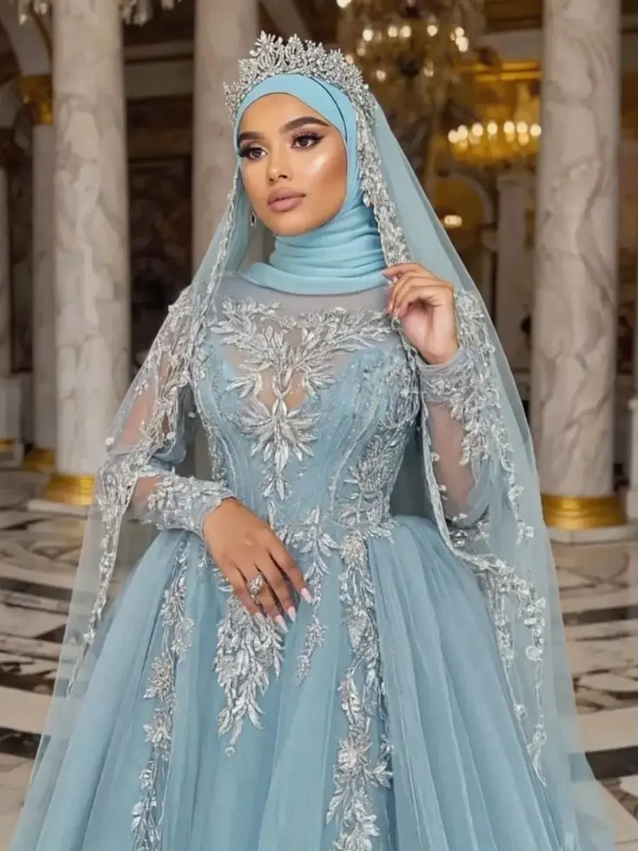 Elegant light blue modest evening gown with intricate floral embroidery on the bodice and sleeves, paired with a matching hijab.
